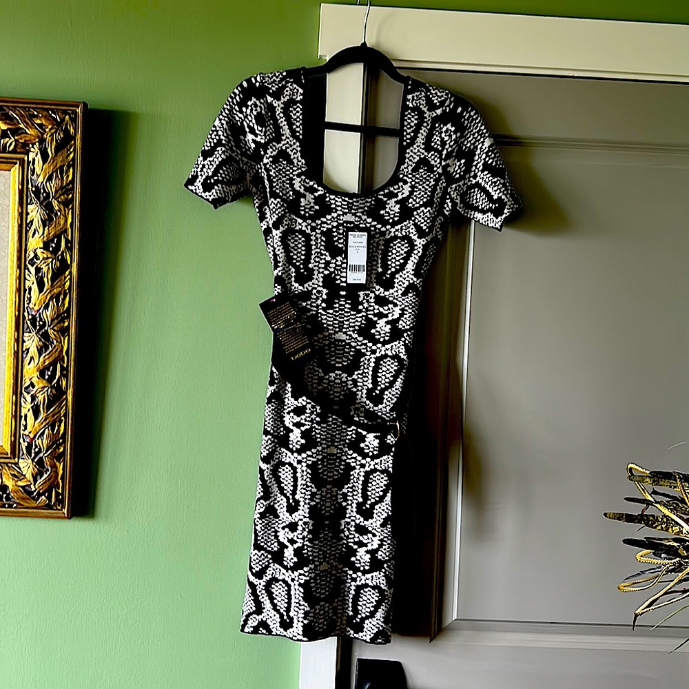 This is a beautiful BeBe black and white size small midi dress! Brand new!